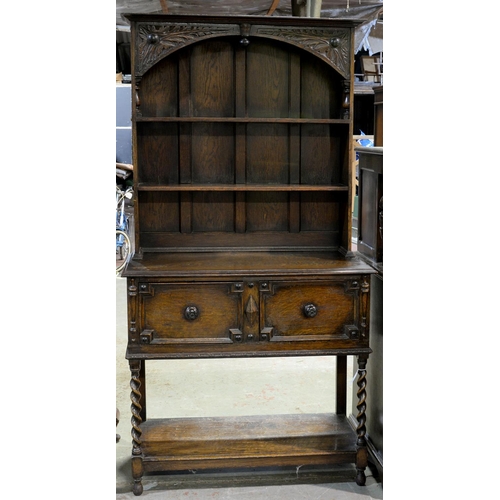 1095 - An oak dresser, the boarded rack with carved spandrels, the lower part with applied mouldings on spi... 