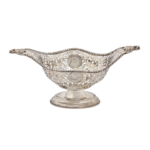 337 - An Edwardian pierced silver fruit bowl, with cast handles and beaded rim, the sides inset with four ... 