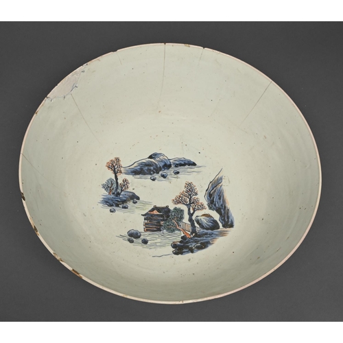 439 - A Chinese blue and white punch bowl with 'clobbered' decoration, late 18th c, painted with landscape... 