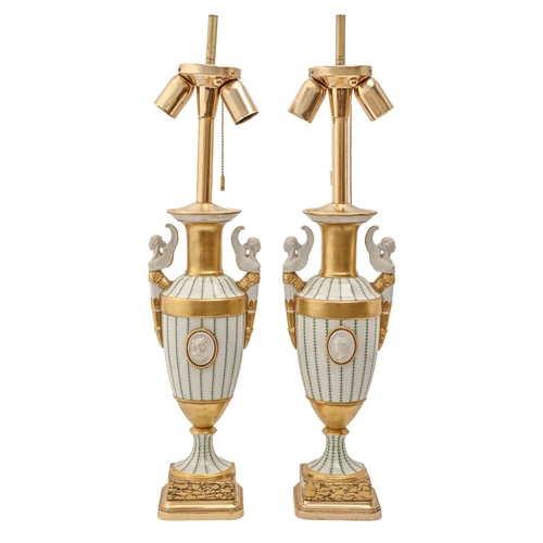 591 - A pair of Continental partly biscuit gilt porcelain vases, late 20th c, in Empire style, on marbled ... 