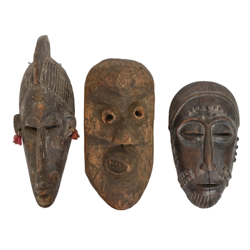 632 - Tribal art. West Africa - a carved wood bambara marka face mask, 39cm and a baule portrait mask, 31c... 