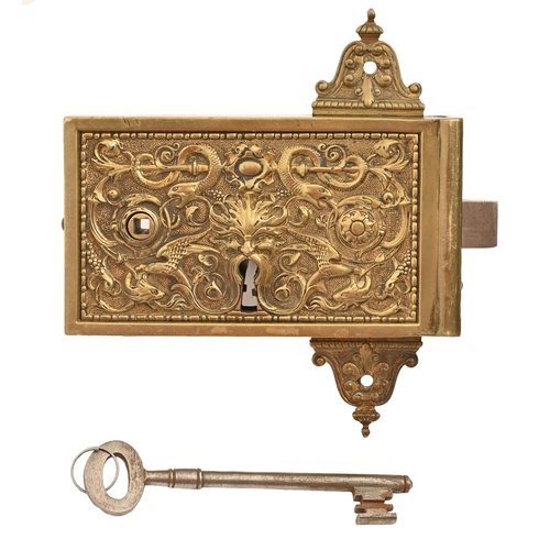 660 - An ornate French cast brass door rim lock, late 19th c, the front with grotesques, 9.5 x 17cm, key... 