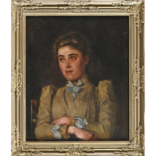 797 - British School, early 20th c - Portrait of a Young Woman, bust length with arms folded, seated, oil ... 