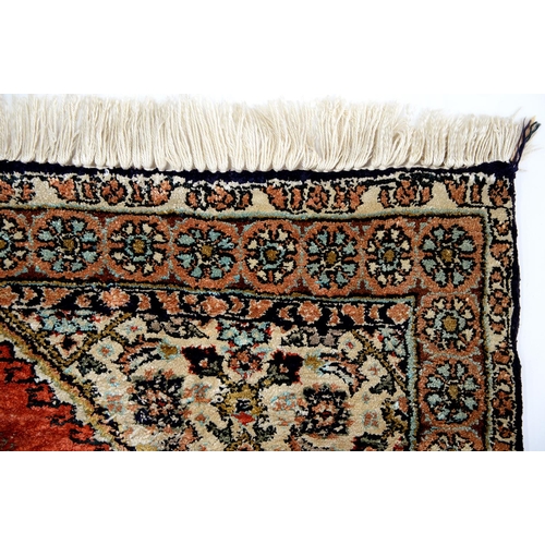 957 - A Persian Ghom silk rug, 81 x 55cm