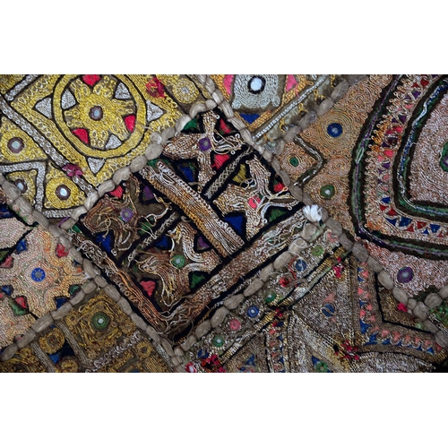 959 - An Indian Banjara rug and machine made rug, 125 x 69cm and 50 x 44cm (2)