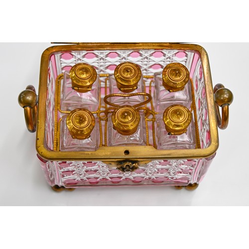 453A - A French gilt lacquered brass mounted pink flashed and cut glass scent casket and set of six square ... 