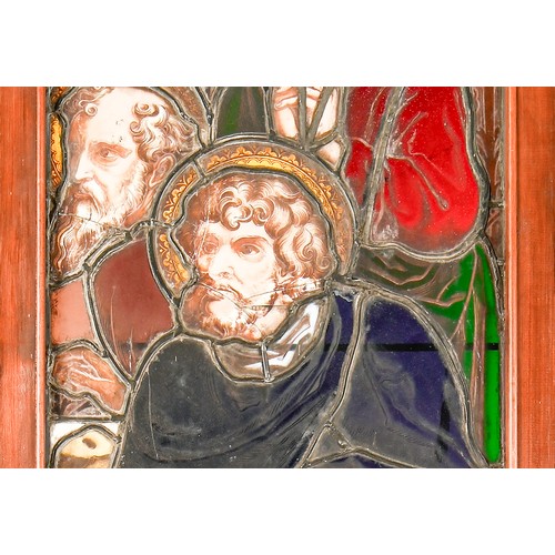 704 - A Victorian stained glass window light of three saints, 188 x 61.5cm including wood frame... 