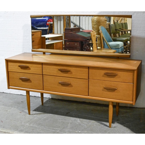 612 - A 1970’s Austine Suite three-piece teak bedroom suite, the mirror back dressing table 144cm w ... 