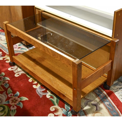 617 - A 1970s teak chest of drawers, 77cm h; 79 x 42cm, a glass topped teak trolley and a contemporary TV ... 