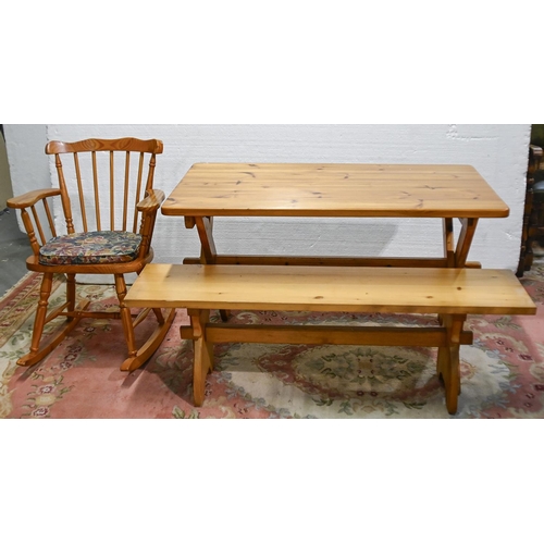 628 - A pine kitchen table, 73cm h; 122 x 68cm, a pine bench, 140cm l and a rocking chair