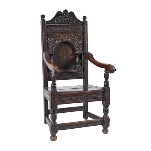 1017 - An oak panel back armchair, 17th c and later, 117cm h