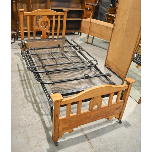 1170 - A Victorian black painted cast iron single bed and a later stained pine bed, 92cm w