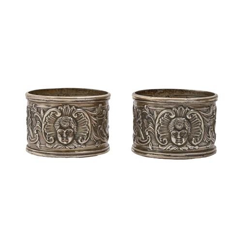 183 - A pair of Victorian silver rococo revival napkin rings, decorated with mask, by The Goldsmiths &... 