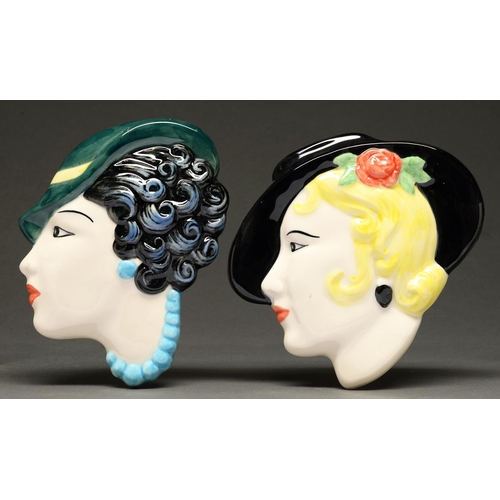 478 - Two slip cast earthenware wall heads, each as a stylish young woman in a hat, in Art Deco style, 18c... 