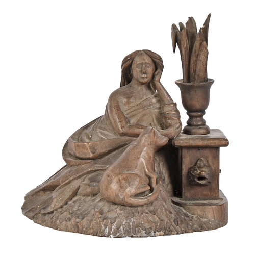 566 - A Black Forest type limewood carving of a seated lady and her cat by a fountain, early 20th c, 15cm ... 