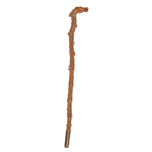 579 - A gnarled wood cane, c1900, the handle carved with the head of a horse with glass eyes, steel and br... 