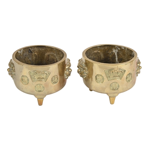 613 - A pair of Chinese brass tripod vessels, 20th c, on three feet, 13cm h; 15cm diam