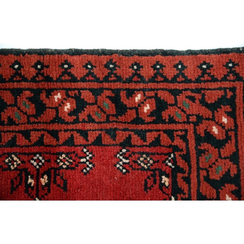 915 - A Pakistan rug, 117 x 74cm, a Persian rug, 79 x 53cm and an Afghan rug, 69 x 50cm (3)... 