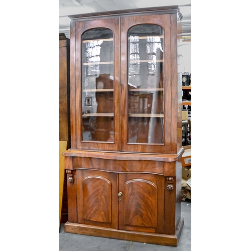 1173 - A Victorian mahogany bookcase, the upper part enclosed by glazed doors with adjustable shelves, on s... 