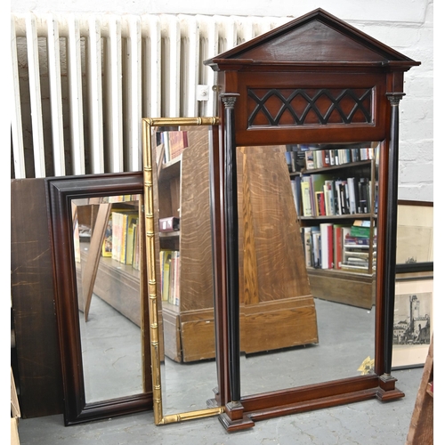 1017 - A Victorian style mahogany mirror of architectural design, the bevelled plate flanked by a pair of g... 