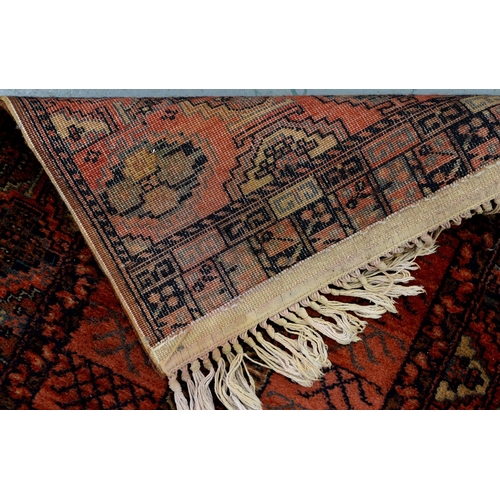 1042 - A Persian rug, 228 x 136cm and two runners, 294 x 102cm and smaller
