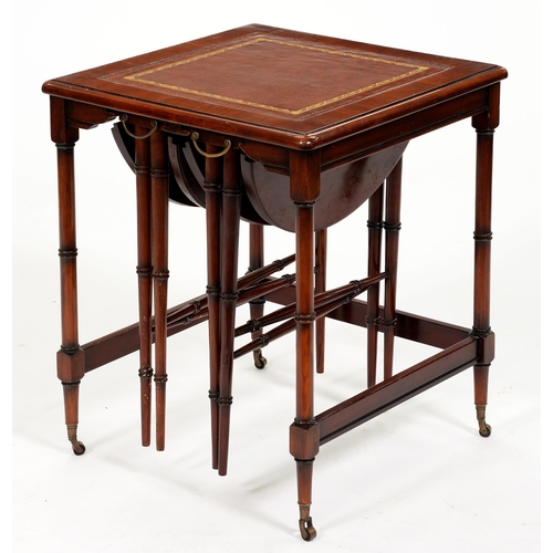 1071 - A mahogany nest of tables in faux bamboo Regency style, with inset tooled leather top, on brass cast... 
