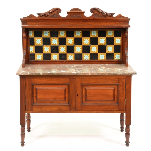 1092 - A Victorian carved mahogany marble topped wash stand, with tiled splash back, the lower part enclose... 