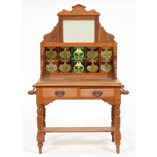 1094 - An early 20th c waxed pine washstand,  the tiled back with bevelled mirror, on turned legs and stret... 