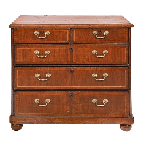 1100 - A walnut chest of drawers, cross grained mouldings, the top crossbanded, on bun feet, 86cm h; 98x 55... 