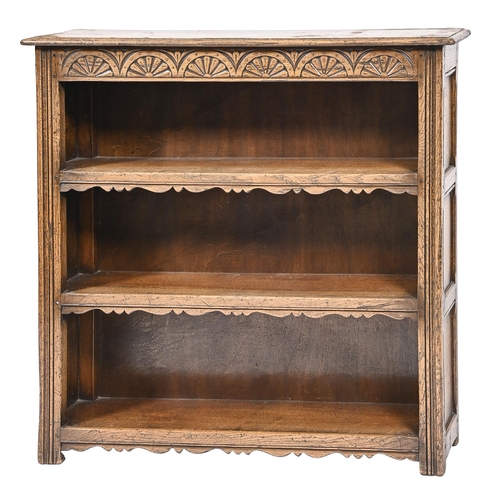 1111 - An antique style carved oak open bookcase,   92cm h; 92 x 22cm and two contemporary panelled oak cup... 