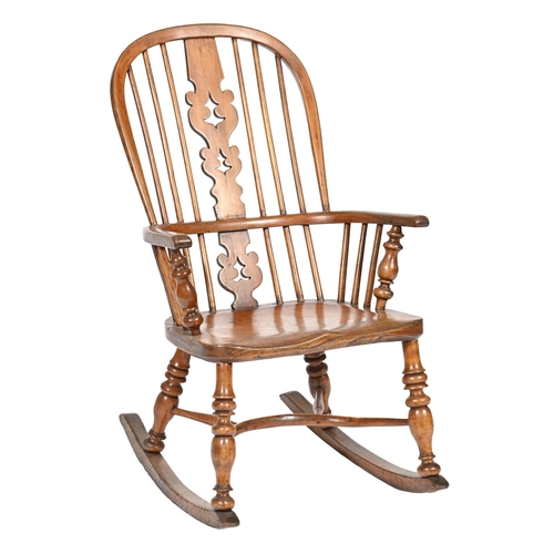 1113 - A Victorian yew and elm Windsor rocking chair,  with pierced splat and spindle back, turned legs and... 