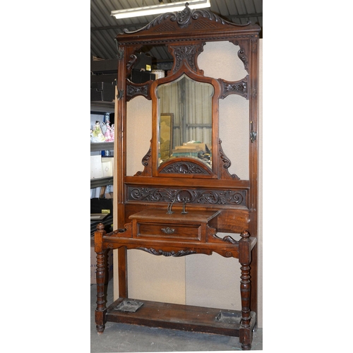 1182 - An Edwardian carved mahogany hall stand, with mirror inset back