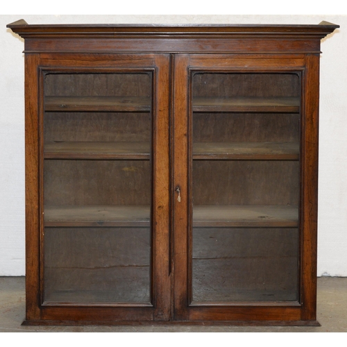 1202 - A Victorian rosewood bookcase with glazed doors, originally on cupboard base