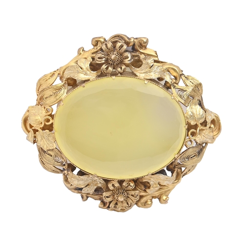 158 - A stained chalcedony brooch, late 19th c,  mounted in gold with filigree and flower surround, 51mm l... 