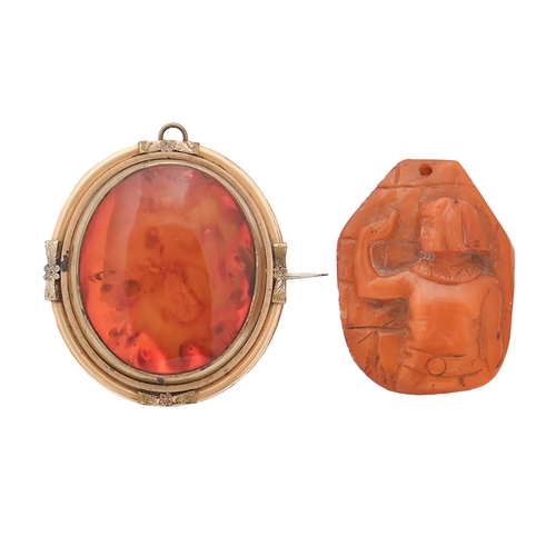 164 - An amber pendant, carved in high relief with the half length figure of a native man, 56mm h and an a... 