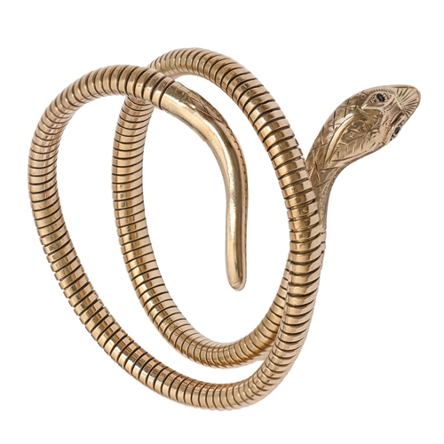 184 - A 9ct gold serpent bangle, Birmingham 1970 and marked STEEL SPRING, 27.7g