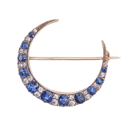 215 - A sapphire and diamond brooch, c1900, in gold, 35mm diam, 5.8g