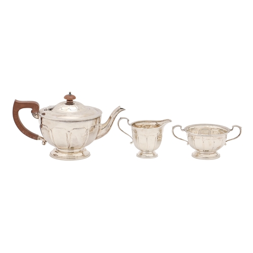 332 - A George V silver tea service, of panelled design with beaded rim, teapot 14.5cm h, by Adie Brothers... 