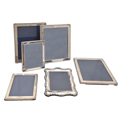 369 - A pair and a set of three Elizabeth II silver photograph frames, with beaded surround, 30 x 25cm and... 