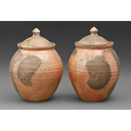 420 - Studio pottery. Pair of jars and covers, thrown, rough textured stoneware, ash glazed, 26cm h... 