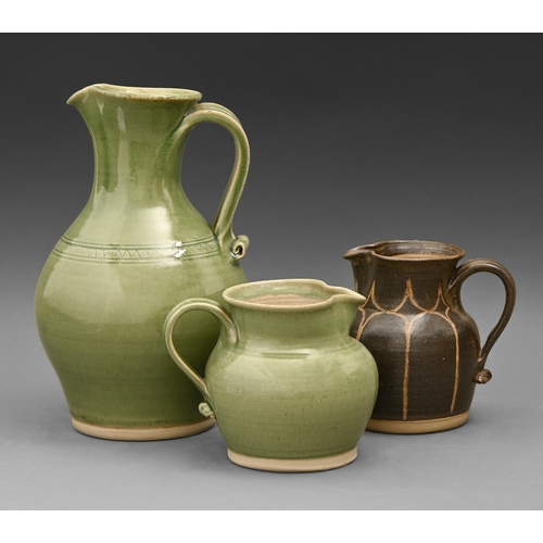 430 - Studio pottery. June Mullarkey (1947 - ) - Three jugs, glazed stoneware, 29cm h and smaller, potter'... 