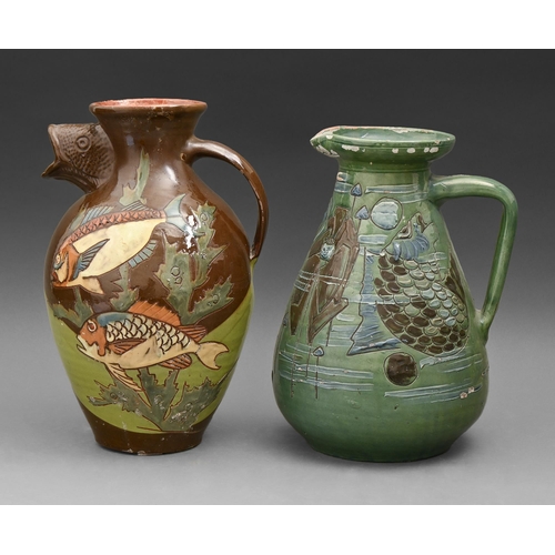 433 - English art pottery. Two C H Brannam slipware jugs, decorated by James Dewdney or by Frederick Bradd... 