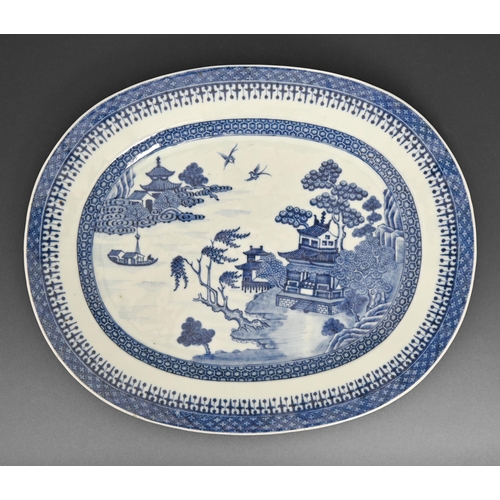 478 - A Chinese export blue and white dish, late 18th c, painted with a river scene in spearhead and cell ... 