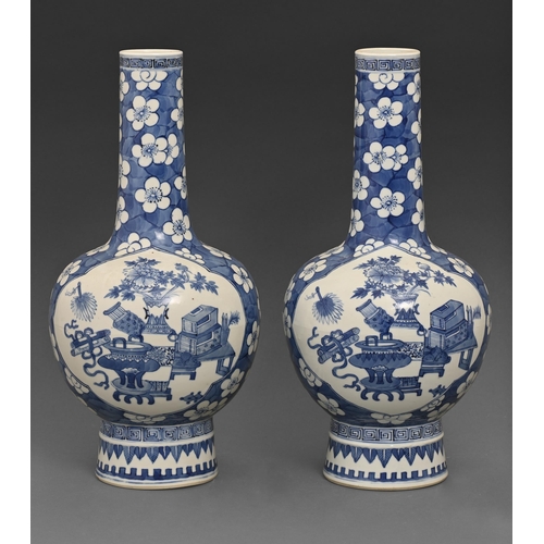 479 - A pair of Chinese blue and white vases, 19th c, painted with auspicious objects reserved on a cracke... 