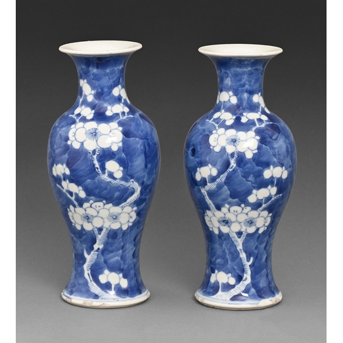 480 - A pair of Chinese blue and white vases, 19th / 20th c, painted with prunus on a cracked ice ground, ... 