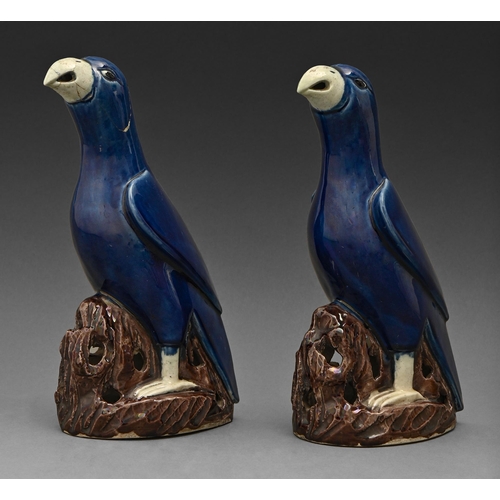 504 - A pair of Chinese blue and aubergine glazed porcelain models of parrots, 19th c , on pierced hollow ... 