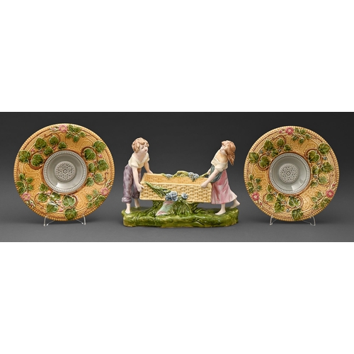 505 - A Czechoslovakian majolica group of a boy and girl with a basket, early 20th c, 25.5cm h and a pair ... 