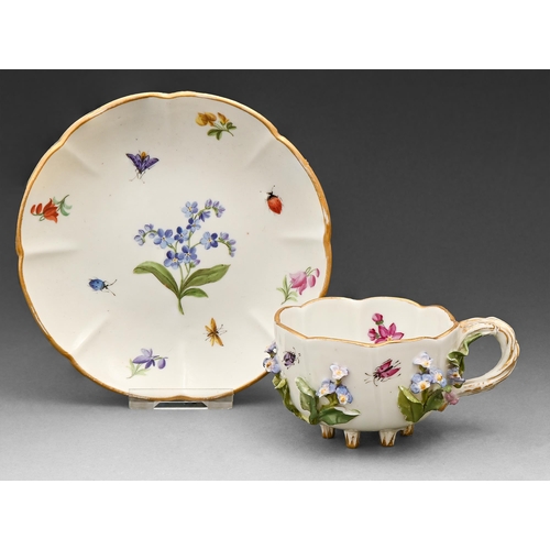 543 - A Meissen floral encrusted cup and saucer, late 19th c, with entwined handle and painted with flower... 