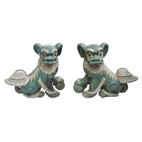 562 - Garden ornaments. A pair of South East Asian glazed pottery dogs of Fo, late 20th c, 52cm h... 