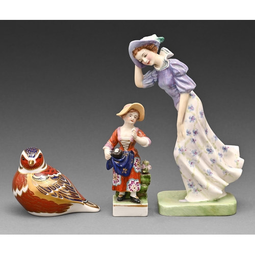 611 - A Royal Doulton bone china figure of Windflower, a smaller German figure of a girl and a Royal Crown... 